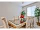 Bright dining room with a mirrored table and comfortable upholstered chairs at 10739 W Sierra Pinta Dr, Peoria, AZ 85373