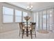 Bright dining area features a modern chandelier, and lots of natural light at 10739 W Sierra Pinta Dr, Peoria, AZ 85373