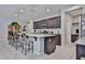 Well-lit kitchen showcases a breakfast bar, a kitchen island and stainless steel microwave at 10739 W Sierra Pinta Dr, Peoria, AZ 85373