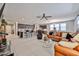 Expansive open-concept living room and kitchen with stainless steel appliances and leather furniture at 10739 W Sierra Pinta Dr, Peoria, AZ 85373