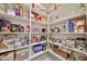 Organized walk-in pantry with fully stocked shelves and tiled floor at 10739 W Sierra Pinta Dr, Peoria, AZ 85373