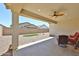 Covered patio area with ceiling fan and outdoor seating overlooking the backyard at 10739 W Sierra Pinta Dr, Peoria, AZ 85373