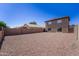 Large, private backyard with gravel landscaping, providing a blank canvas for creating your dream outdoor space at 11215 W Heatherbrae Dr, Phoenix, AZ 85037