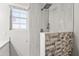 Modern bathroom features tiled shower with a large rain-style shower head and tile accent at 11215 W Heatherbrae Dr, Phoenix, AZ 85037
