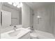 Bright bathroom with tub and tiled shower, features a modern vanity and fixtures at 11215 W Heatherbrae Dr, Phoenix, AZ 85037