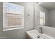 Modern bathroom with new fixtures, window and vanity with chrome faucet at 11215 W Heatherbrae Dr, Phoenix, AZ 85037