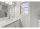 Modern bathroom features a stylish vanity with granite countertops, and tile walls at 11215 W Heatherbrae Dr, Phoenix, AZ 85037