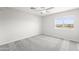Bright bedroom with a ceiling fan, carpet, and natural light from the window at 11215 W Heatherbrae Dr, Phoenix, AZ 85037
