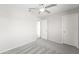 Neutral bedroom features an on-suite bathroom, closet, and ceiling fan at 11215 W Heatherbrae Dr, Phoenix, AZ 85037