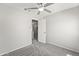 Neutral bedroom offers a ceiling fan and entrance to on-suite bathroom at 11215 W Heatherbrae Dr, Phoenix, AZ 85037