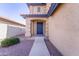 Front exterior shot of home showcasing a blue front door and xeriscaping at 11215 W Heatherbrae Dr, Phoenix, AZ 85037