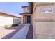 Front exterior shot of home showcasing a blue front door and xeriscaping at 11215 W Heatherbrae Dr, Phoenix, AZ 85037