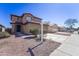 Two-story home featuring a well-manicured lawn and desert landscaping with a spacious two-car driveway at 11215 W Heatherbrae Dr, Phoenix, AZ 85037