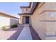 Charming front facade with address, walkway, and blue door nestled in desert landscape, offering a warm welcome at 11215 W Heatherbrae Dr, Phoenix, AZ 85037