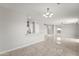 Bright, open-concept living room with tile flooring and modern lighting fixtures at 11215 W Heatherbrae Dr, Phoenix, AZ 85037