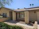 Covered front porch with decorative columns, shutters on windows, and desert landscaping at 12016 N 45Th Ave, Glendale, AZ 85304