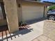 Garage door on a home with stucco exterior and a neatly maintained driveway at 12016 N 45Th Ave, Glendale, AZ 85304