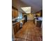 Spacious kitchen with wood cabinets, skylight, tile floor and black appliances at 12016 N 45Th Ave, Glendale, AZ 85304