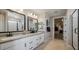 Bright bathroom featuring double vanity, modern fixtures, sleek mirrors, and walk-in shower at 12712 W Corona Ave, Avondale, AZ 85323