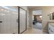 Modern bathroom showing the glass-enclosed shower and dual sink vanity with modern accents at 12712 W Corona Ave, Avondale, AZ 85323