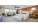 Bright bedroom with large windows, accent wall, ceiling fan, and comfortable seating area at 12712 W Corona Ave, Avondale, AZ 85323