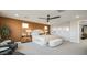 Spacious bedroom with a paneled accent wall, ceiling fan, and contemporary furnishings at 12712 W Corona Ave, Avondale, AZ 85323