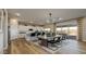 Bright open kitchen and dining area with modern appliances, an island with seating, and a dining table for six at 12712 W Corona Ave, Avondale, AZ 85323