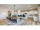 Open-concept kitchen and dining area featuring a large island, modern appliances, and stylish dining table at 12712 W Corona Ave, Avondale, AZ 85323