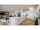 Well-lit kitchen featuring a large island, stainless steel appliances, and an adjacent dining area at 12712 W Corona Ave, Avondale, AZ 85323