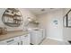 Clean laundry room with modern appliances and ample counter space at 12712 W Corona Ave, Avondale, AZ 85323