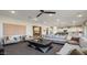 Expansive living room and open kitchen featuring contemporary furnishings, and plush seating at 12712 W Corona Ave, Avondale, AZ 85323