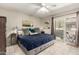 Comfortable bedroom featuring tiled floor, ceiling fan, and sliding glass door to private patio at 1402 E Guadalupe Rd # 114, Tempe, AZ 85283