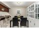 Bright dining area featuring modern black table and chairs, with a built-in cabinet, and a breakfast bar at 1402 E Guadalupe Rd # 114, Tempe, AZ 85283