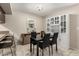 Clean dining room with a black table set with room for four, dark wood cabinets, and breakfast bar seating at 1402 E Guadalupe Rd # 114, Tempe, AZ 85283