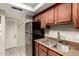 Efficient kitchen features stainless steel appliances, granite countertops, updated fixtures, and wooden cabinets at 1402 E Guadalupe Rd # 114, Tempe, AZ 85283