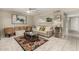 Cozy living room features tile floors, a ceiling fan, a comfortable couch, and an eye-catching accent rug at 1402 E Guadalupe Rd # 114, Tempe, AZ 85283
