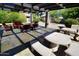 Inviting covered patio with stone tile, decorative stone tables, and comfortable seating at 1402 E Guadalupe Rd # 114, Tempe, AZ 85283