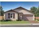 Charming single-story home featuring desert landscaping and a welcoming two-car garage at 1432 W Ridge Rd, Apache Junction, AZ 85120