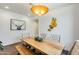 A dining area showcases a wood table with chairs and bench seating, complemented by modern decor at 14393 W Wethersfield Rd, Surprise, AZ 85379