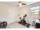Bright exercise room with closet, stationary bike, and weight set at 14393 W Wethersfield Rd, Surprise, AZ 85379