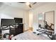 Bright exercise room featuring modern equipment, neutral tones and a light wood floor at 14393 W Wethersfield Rd, Surprise, AZ 85379