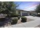 Inviting home featuring a manicured front yard, large windows, and a two-car garage at 14393 W Wethersfield Rd, Surprise, AZ 85379