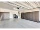 Spacious garage with epoxy flooring and custom cabinetry for ample storage at 14393 W Wethersfield Rd, Surprise, AZ 85379