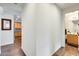 Hallway with wood-look tile floors, leading to the kitchen and bathroom at 14393 W Wethersfield Rd, Surprise, AZ 85379