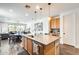 Open concept kitchen with an island, stainless steel appliances, and view to dining and living spaces at 14393 W Wethersfield Rd, Surprise, AZ 85379