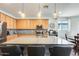 Kitchen island with a gray countertop and seating, complete with stainless steel appliances and cabinetry at 14393 W Wethersfield Rd, Surprise, AZ 85379