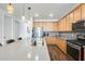 Spacious kitchen featuring modern stainless steel appliances, stone countertops, and ample cabinet space at 14393 W Wethersfield Rd, Surprise, AZ 85379