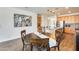 Kitchen and dining area featuring stainless steel appliances, kitchen island, and wood cabinets at 14393 W Wethersfield Rd, Surprise, AZ 85379