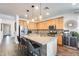 A spacious kitchen features an island, stainless steel appliances, and ample counter space at 14393 W Wethersfield Rd, Surprise, AZ 85379