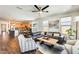 Spacious living area with kitchen view, modern furnishings, and an open-concept layout at 14393 W Wethersfield Rd, Surprise, AZ 85379